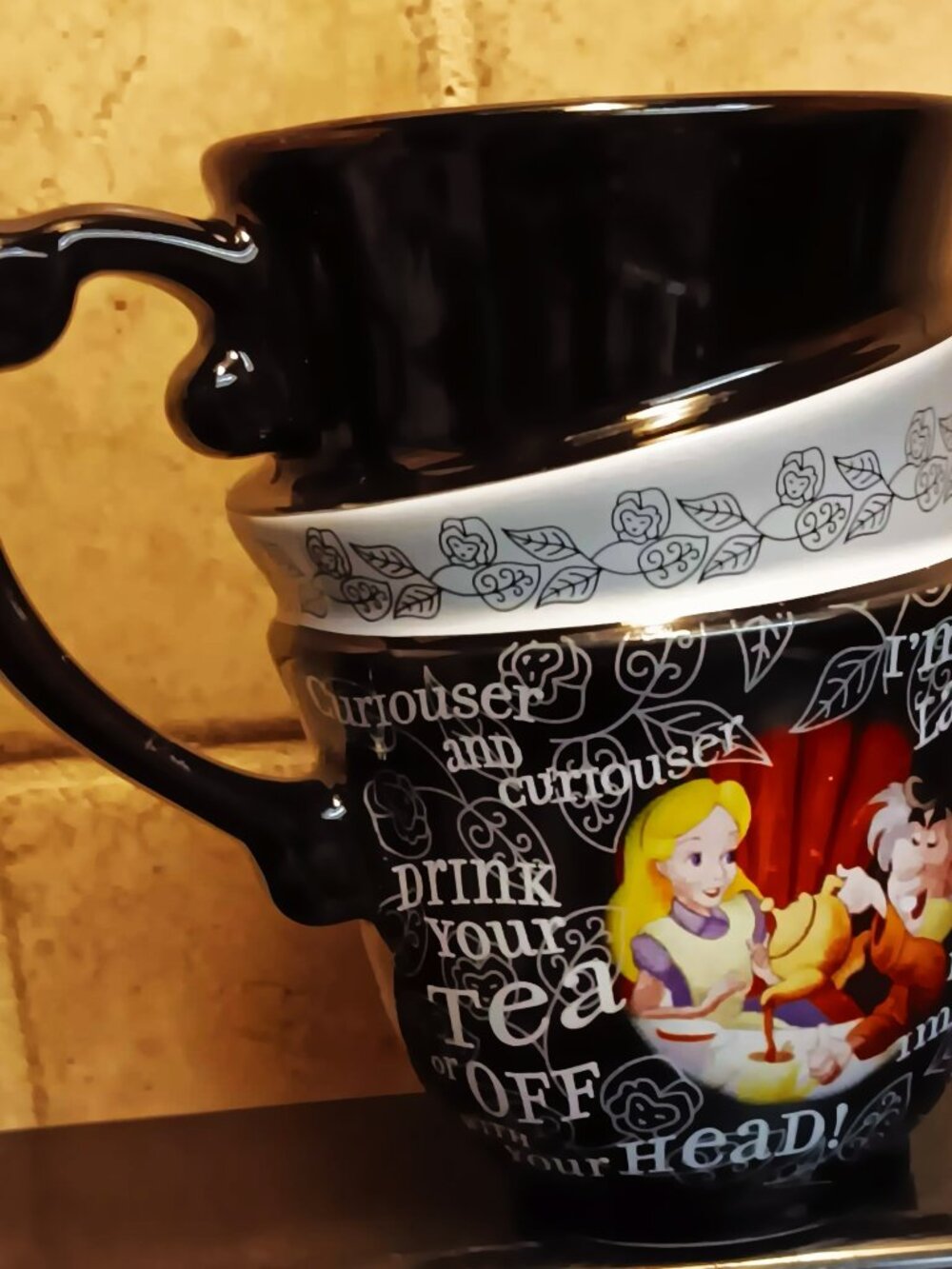 Walt Disney Parks Alice in Wonderland 11-ounce mug. Black, red, yellow, white.